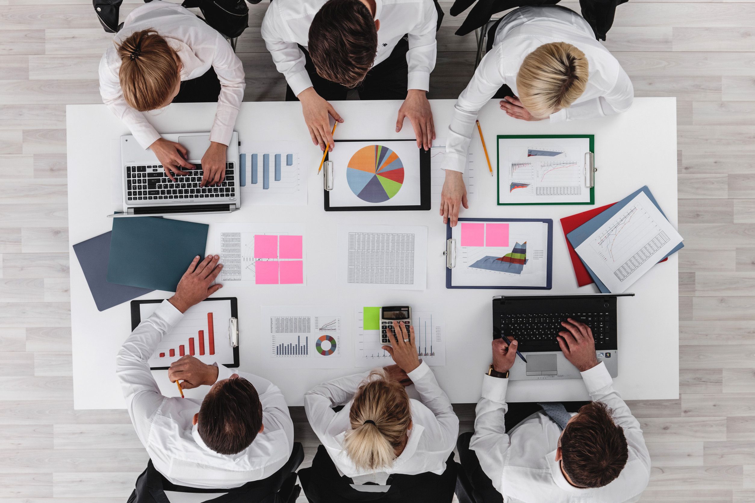 Marketing team planning campaign with charts and laptops